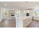 Spacious open-concept kitchen with large island, modern appliances, hardwood floors, and natural light at 7515 Woolf Way, Cumming, GA 30028