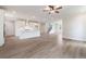 Open-concept living space with hardwood floors, kitchen island, and ample natural light at 7515 Woolf Way, Cumming, GA 30028
