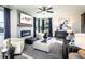 Bright living room with a fireplace, modern decor, comfortable seating and a ceiling fan at 7515 Woolf Way, Cumming, GA 30028