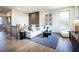 Bright living room with a large white sofa, accent rug, modern decor and a loft area at 7515 Woolf Way, Cumming, GA 30028