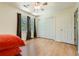Well-lit bedroom featuring hardwood floors, double closets, a ceiling fan, and three large windows at 1872 Lake Lucerne Sw Dr, Lilburn, GA 30047