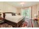 Tranquil bedroom featuring neutral walls, a sliding glass door to the outside, and a cozy atmosphere at 1872 Lake Lucerne Sw Dr, Lilburn, GA 30047