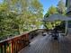 Outdoor deck showcasing a view of the lake with patio furniture, bench seating and wooded landscape at 1872 Lake Lucerne Sw Dr, Lilburn, GA 30047