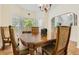 Elegant dining room featuring a wooden table, upholstered chairs, and ample natural light at 1872 Lake Lucerne Sw Dr, Lilburn, GA 30047