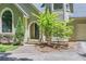 Inviting front entrance features a beautiful arched doorway and lush landscaping at 1872 Lake Lucerne Sw Dr, Lilburn, GA 30047