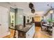 Open kitchen with island, granite counters, and seating, seamlessly connected to the living area at 1872 Lake Lucerne Sw Dr, Lilburn, GA 30047