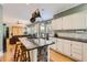 Open-concept kitchen with island, granite counters, and seating, seamlessly connected to the living area at 1872 Lake Lucerne Sw Dr, Lilburn, GA 30047