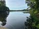 Picturesque lake view from the property with serene water and lush trees at 1872 Lake Lucerne Sw Dr, Lilburn, GA 30047