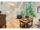 Sun-filled living room boasts an arched window, hardwood floors and inviting seating area at 1872 Lake Lucerne Sw Dr, Lilburn, GA 30047