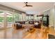 Spacious living room featuring hardwood floors and a leather sofa, with views of the outdoor deck at 1872 Lake Lucerne Sw Dr, Lilburn, GA 30047