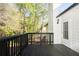 Exterior deck of home featuring black metal railing, a door to the house, and views of the yard at 4080 Birch Bark Way, Douglasville, GA 30135