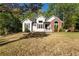 Charming two-story home with a well-manicured lawn, brick and vinyl siding, and a welcoming front porch at 4080 Birch Bark Way, Douglasville, GA 30135