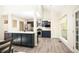 Modern kitchen features navy blue cabinets, stainless steel appliances, quartz countertops, and wood-look floors at 4080 Birch Bark Way, Douglasville, GA 30135