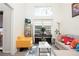 Bright living room featuring a piano, comfortable seating, and natural light from the large window at 4080 Birch Bark Way, Douglasville, GA 30135