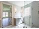 Elegant bathroom with dual vanities, glass shower, and gray cabinetry at 5235 Memento Trace, Cumming, GA 30040
