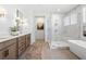 Elegant bathroom with a soaking tub, glass shower, double vanity, and modern fixtures at 5349 Memento Trace, Cumming, GA 30040