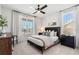 Cozy bedroom with two windows, ceiling fan, and neutral decor at 5349 Memento Trace, Cumming, GA 30040