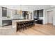 Modern kitchen with a large island, black cabinets, and stainless steel appliances at 5349 Memento Trace, Cumming, GA 30040