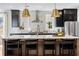 Bright kitchen with an island, seating, pendant lighting, and stainless steel appliances at 5349 Memento Trace, Cumming, GA 30040