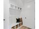 Mudroom with built-in storage, a bench, and woven baskets at 5349 Memento Trace, Cumming, GA 30040