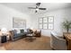 Comfortable home office with a ceiling fan, sofa, chairs, and rug at 5349 Memento Trace, Cumming, GA 30040
