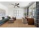Bright home office featuring natural light, ceiling fan, and stylish furnishings at 5349 Memento Trace, Cumming, GA 30040