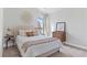 Bright bedroom with a cream bed, decorative mirror and plush carpet flooring at 545 Paces Dr, Lithia Springs, GA 30122