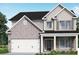 Charming two-story home with a two-car garage, brick accents and covered porch at 545 Paces Dr, Lithia Springs, GA 30122