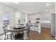 Open-concept kitchen features white cabinets, granite countertops, and stainless steel appliances at 545 Paces Dr, Lithia Springs, GA 30122