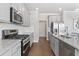 Well-appointed kitchen features stainless steel appliances, granite counters, and subway tile at 545 Paces Dr, Lithia Springs, GA 30122