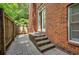 Charming back patio with brick pavers, a small brick staircase, and a privacy fence at 774 Piedmont Ne Ave # 11B, Atlanta, GA 30308