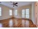 An empty bedroom with beautiful hardwood floors, ceiling fan, and a door to the outside balcony at 774 Piedmont Ne Ave # 11B, Atlanta, GA 30308