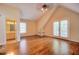 A spacious empty bedroom with hardwood floors and door to an exterior balcony and a bathroom at 774 Piedmont Ne Ave # 11B, Atlanta, GA 30308