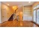 Spacious living room with hardwood floors, built-in shelves, and staircase with natural light at 774 Piedmont Ne Ave # 11B, Atlanta, GA 30308