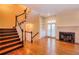 Cozy living area with hardwood floors, fireplace, and a staircase creating a warm and inviting space at 774 Piedmont Ne Ave # 11B, Atlanta, GA 30308