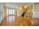 Open concept living area boasting gleaming hardwood floors, staircase and bright windows at 774 Piedmont Ne Ave # 11B, Atlanta, GA 30308