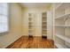 Spacious walk-in closet with installed shelving and hardwood floors for optimal organization at 774 Piedmont Ne Ave # 11B, Atlanta, GA 30308
