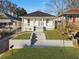 Charming bungalow featuring a landscaped yard and welcoming staircase leading to the front porch at 1024 Herndon Nw St, Atlanta, GA 30318