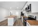 Modern kitchen with stainless steel appliances, butcher block counters, and a breakfast bar at 1024 Herndon Nw St, Atlanta, GA 30318