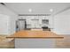 Spacious kitchen with white cabinetry, butcher block countertops, and stainless steel appliances at 1024 Herndon Nw St, Atlanta, GA 30318