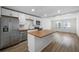 Modern kitchen with stainless steel appliances, butcher block counters, and a breakfast bar at 1024 Herndon Nw St, Atlanta, GA 30318
