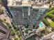Aerial view showcasing the high-rise building, courtyard, pool, and surrounding urban landscape at 1080 Peachtree Ne St # 2416, Atlanta, GA 30309