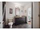 Bathroom with a vanity, framed mirror, toilet, and dark tiled flooring at 1080 Peachtree Ne St # 2416, Atlanta, GA 30309