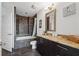 Modern bathroom with tiled shower, granite countertop vanity, and neutral decor at 1080 Peachtree Ne St # 2416, Atlanta, GA 30309
