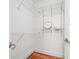 Walk-in closet with wire shelving, hardwood floors, and a clock at 1080 Peachtree Ne St # 2416, Atlanta, GA 30309