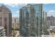 View of a modern high-rise building with glass balconies, set against the backdrop of the city skyline at 1080 Peachtree Ne St # 2416, Atlanta, GA 30309