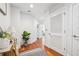 Hallway with hardwood floors, white walls, and storage leading to other areas of the home at 1080 Peachtree Ne St # 2416, Atlanta, GA 30309