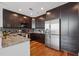 Contemporary kitchen featuring stainless steel appliances, dark wood cabinets and granite countertops at 1080 Peachtree Ne St # 2416, Atlanta, GA 30309
