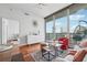 Bright living room with hardwood floors, modern furniture, and floor-to-ceiling windows with balcony access at 1080 Peachtree Ne St # 2416, Atlanta, GA 30309
