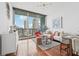 Open concept living room with hardwood floors, modern decor, and stunning city views at 1080 Peachtree Ne St # 2416, Atlanta, GA 30309